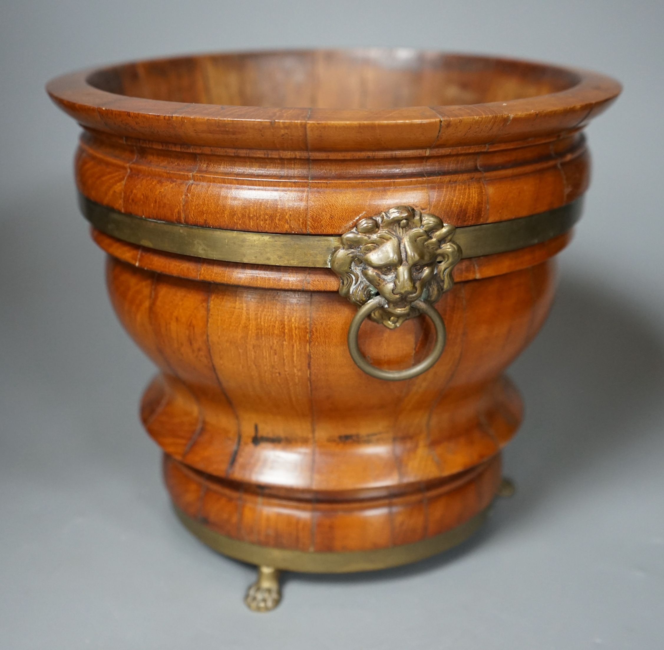 A 19th century brass bound coopered planter with loin mask handles, 19cms high